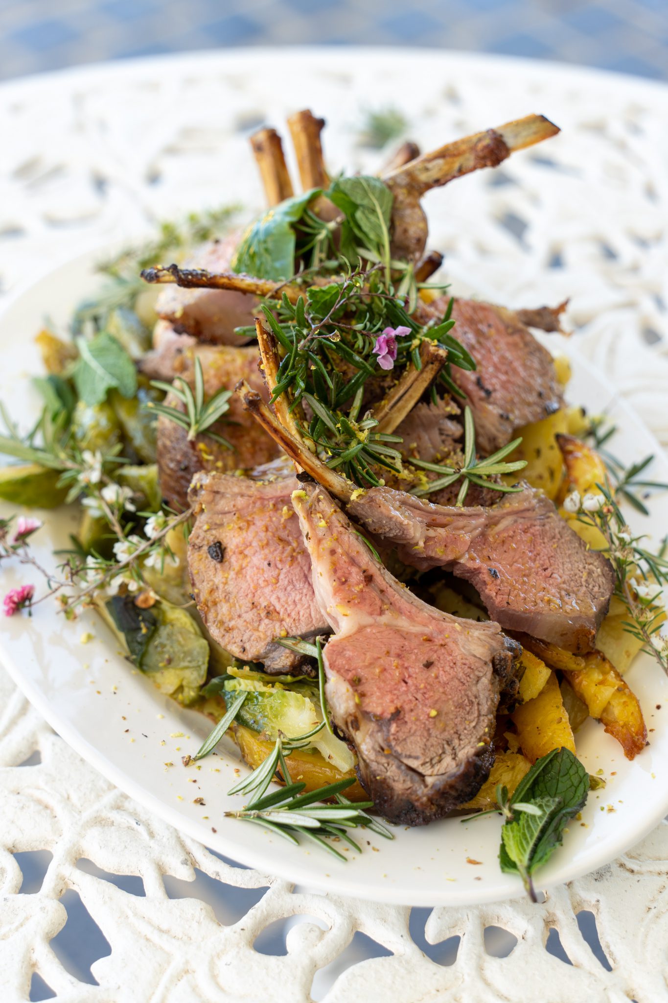 roast lamb chops and herbs on a white plate prepared by a professional chef at heartwood farm cottage