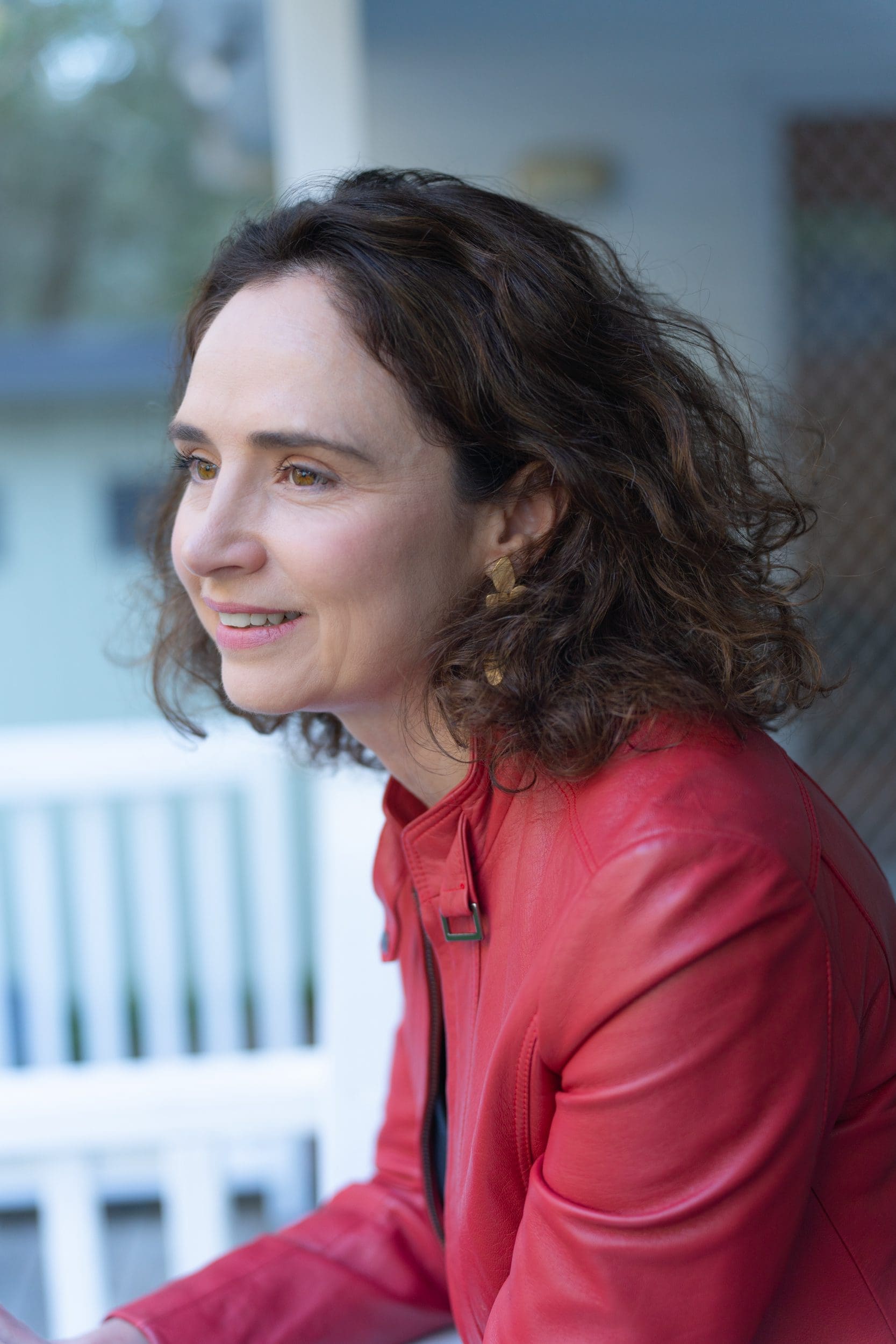 Ext: Young dark-haired woman in red having a high-quality headshot taken by professional photographer Georgie Greene in Sydney NSW