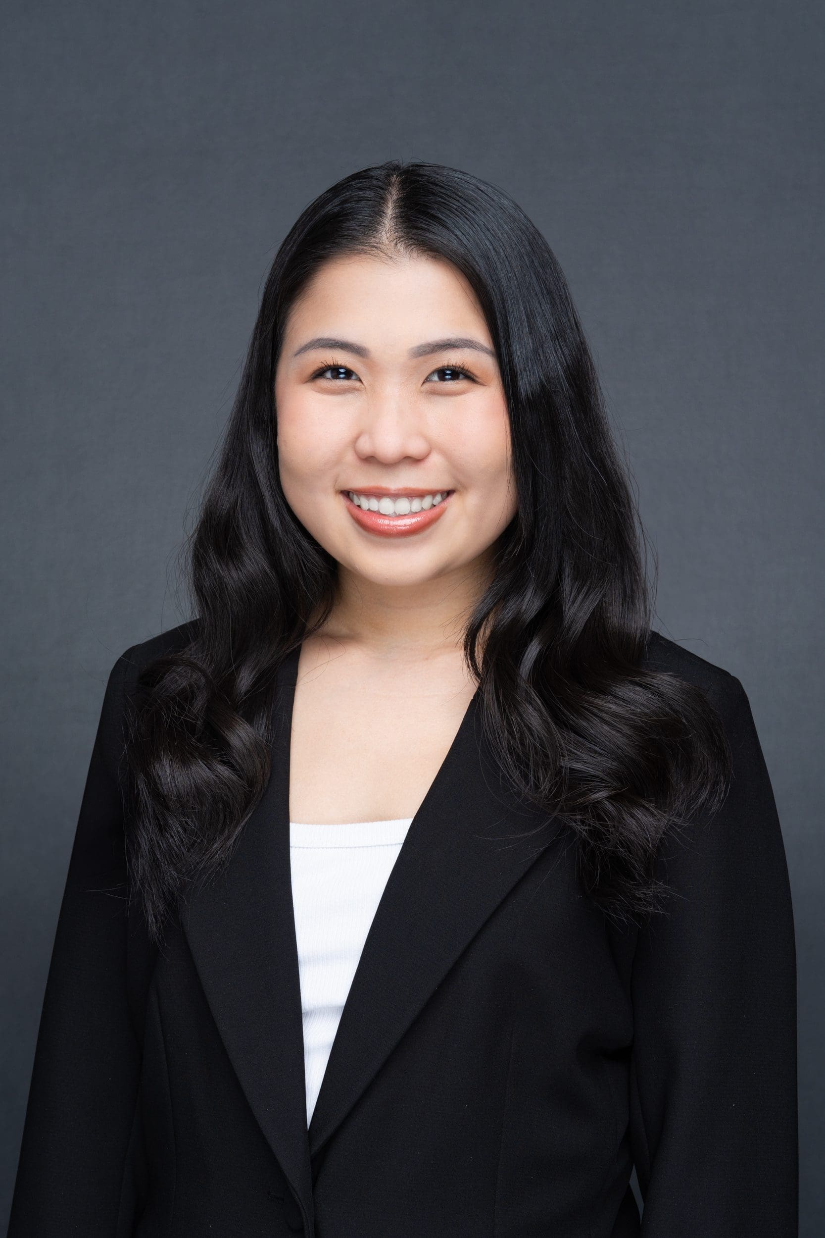 Int: Young Asian woman in a black jacket having Business Head Shot taken by headshot photographer Georgie Greene in Sydney NSW
