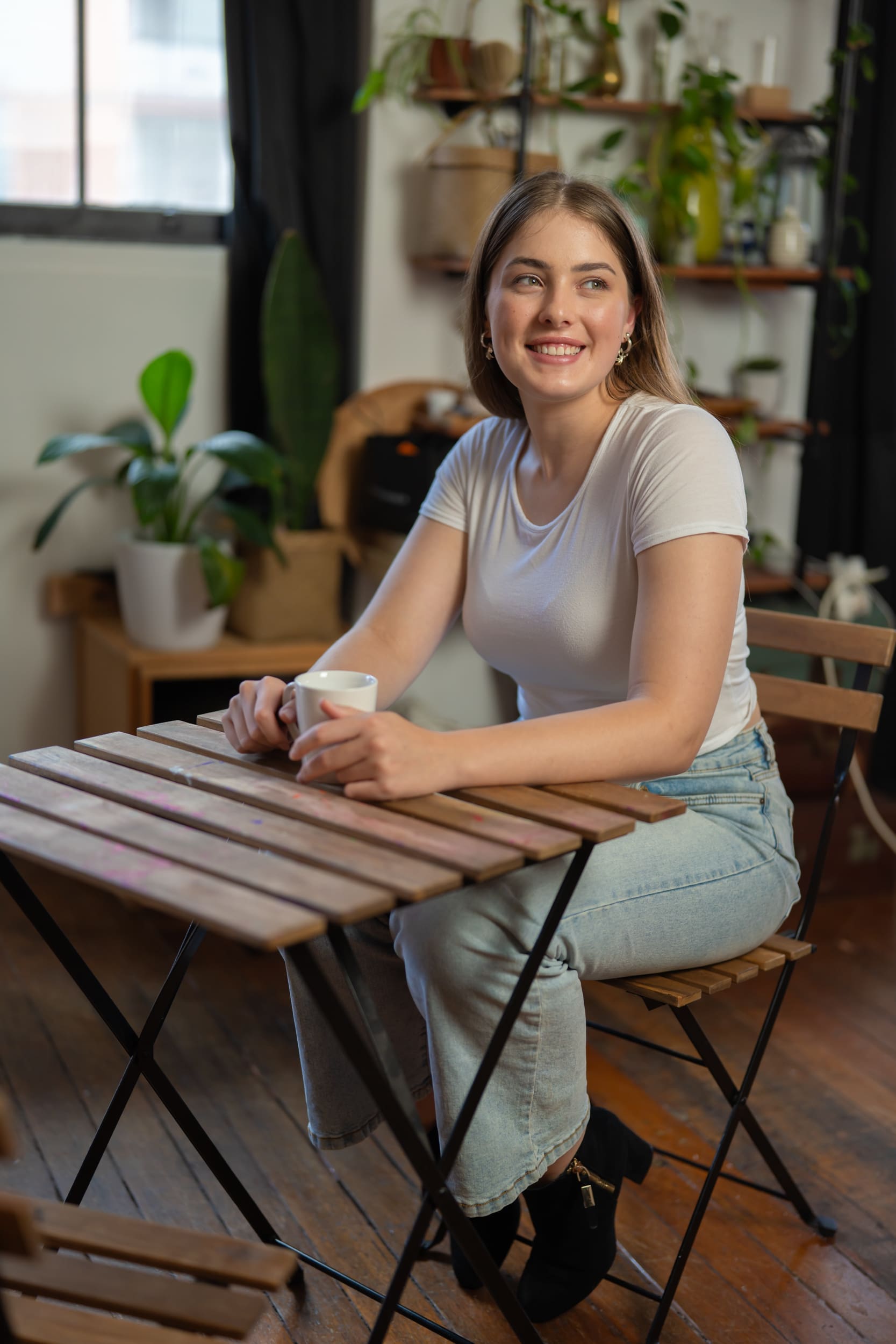 Ext: Young woman sitting at a table having a candid portrait taken by dating photographer Georgie Greene in Sydney NSW