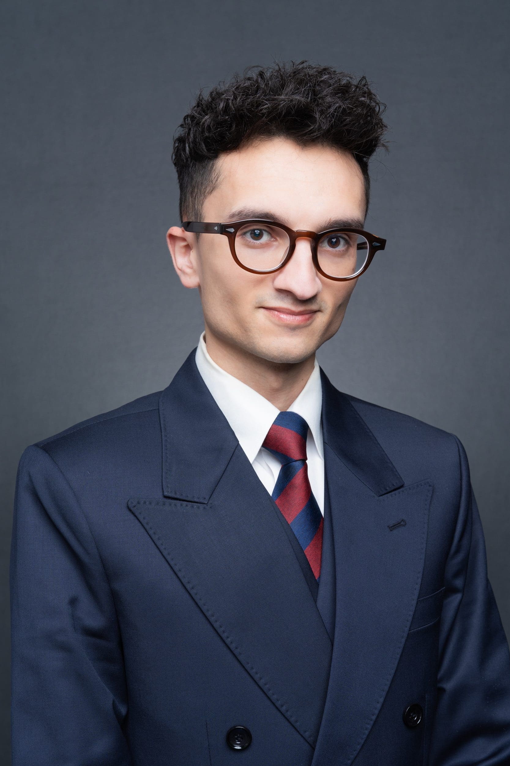 Int: Dark-haired man with glasses having his corporate headshot taken by Sydney Photographer Georgie Greene in Sydney NSW