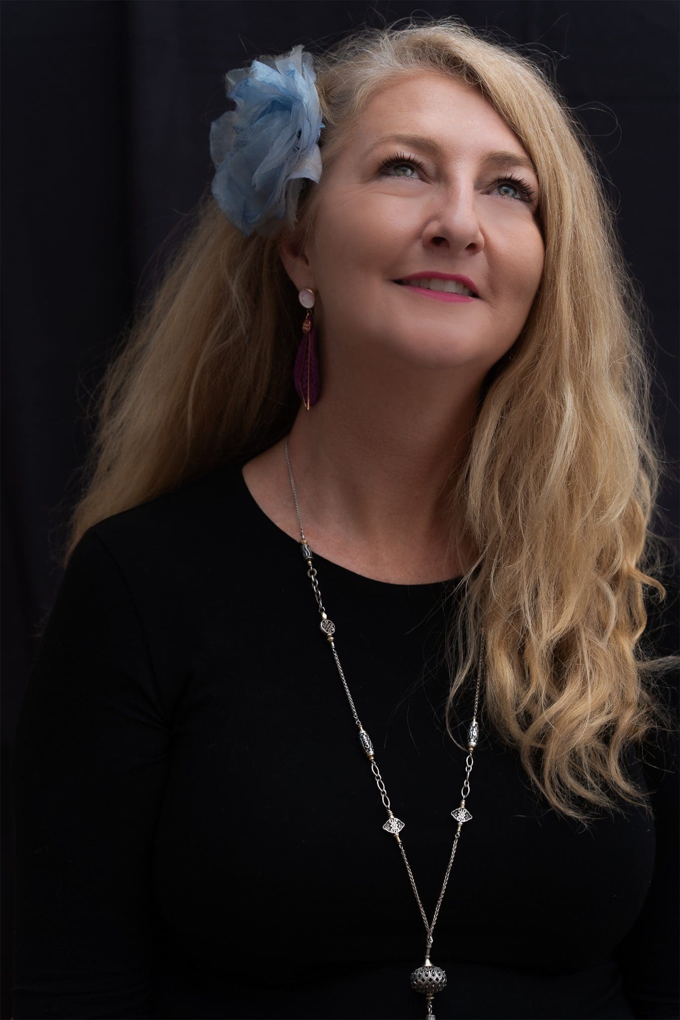 Woman with long blonde hair and a black top having her creative portrait taken by professional photographer Georgie Greene in Sydney NSW