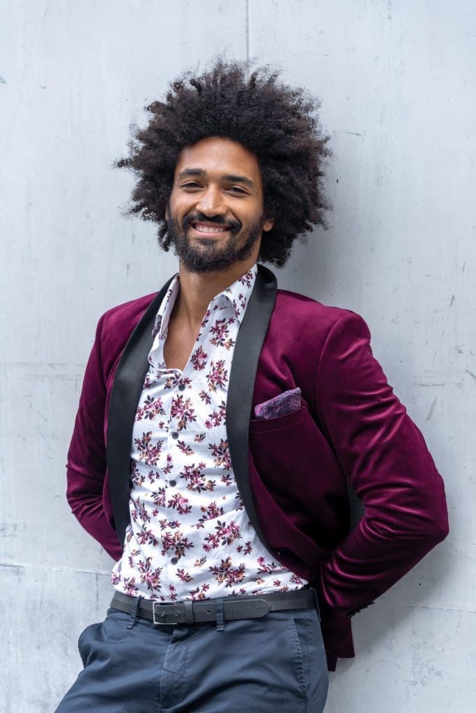 Ext: Young black man wearing purple having a Sydney dating photo taken by dating photographer Georgie Greene in Sydney NSW