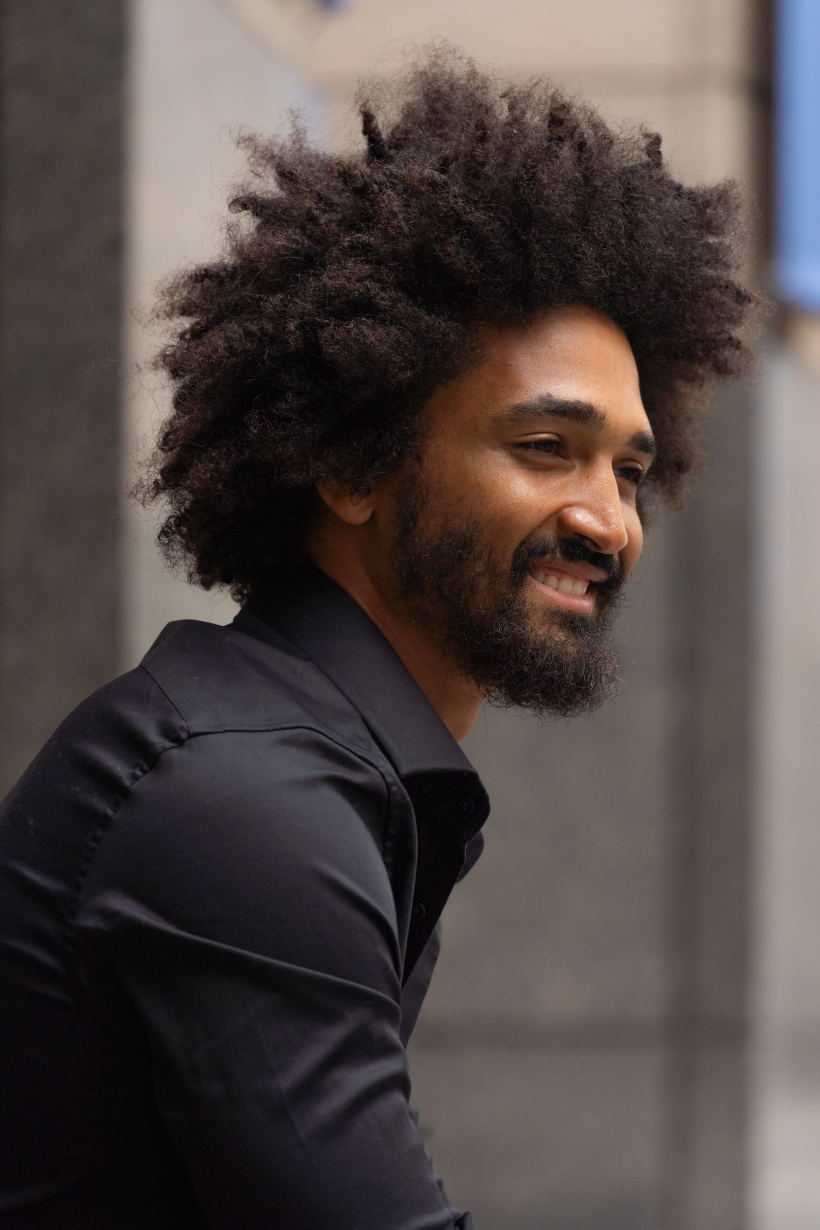 Ext: Young black man wearing a black shirt having dating photo taken by online dating photographer Georgie Greene in Sydney NSW
