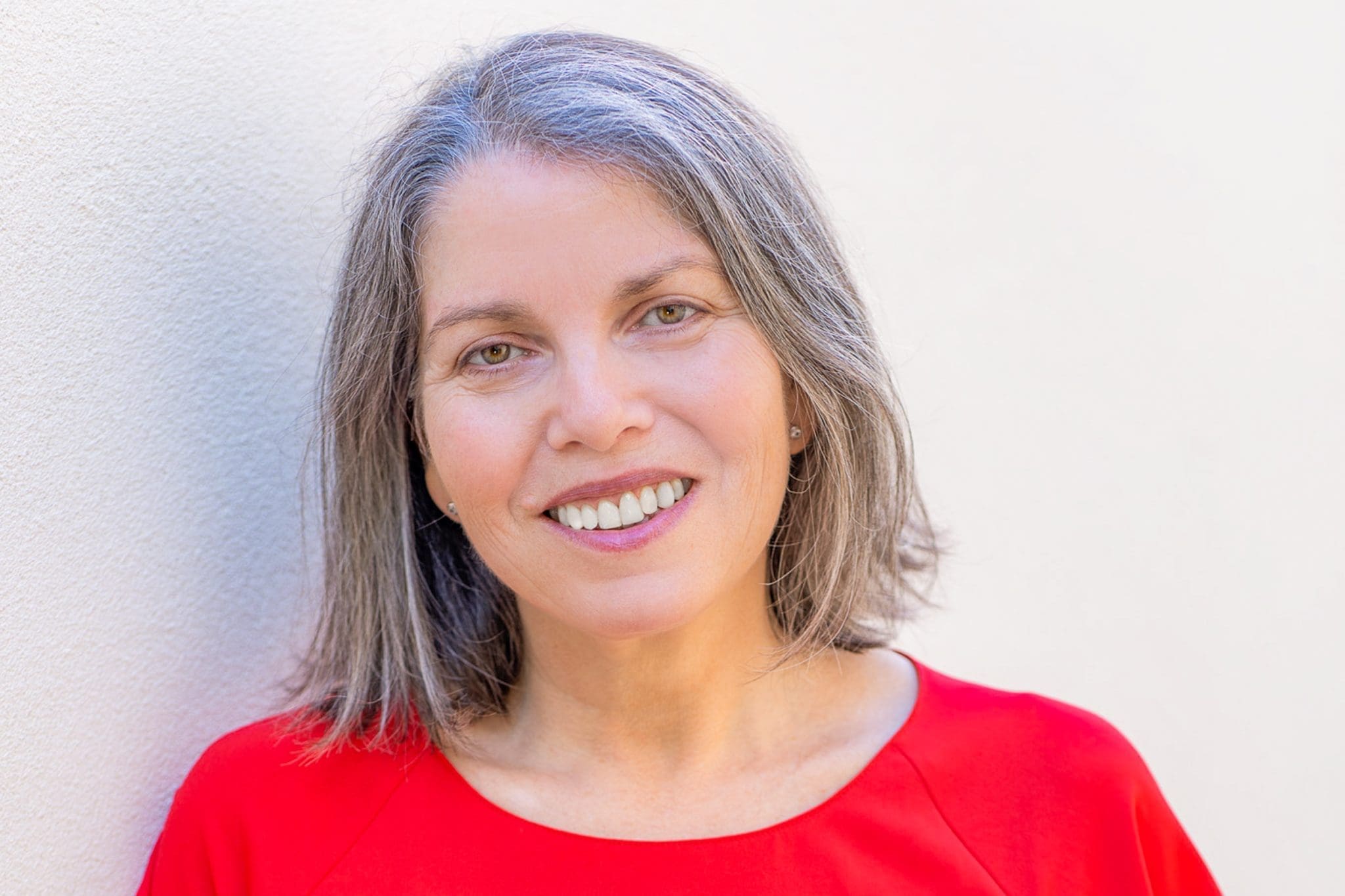 Ext: Leadership coach/author wearing a red top having her branding photos taken by portrait photographer Georgie Greene in Sydney NSW