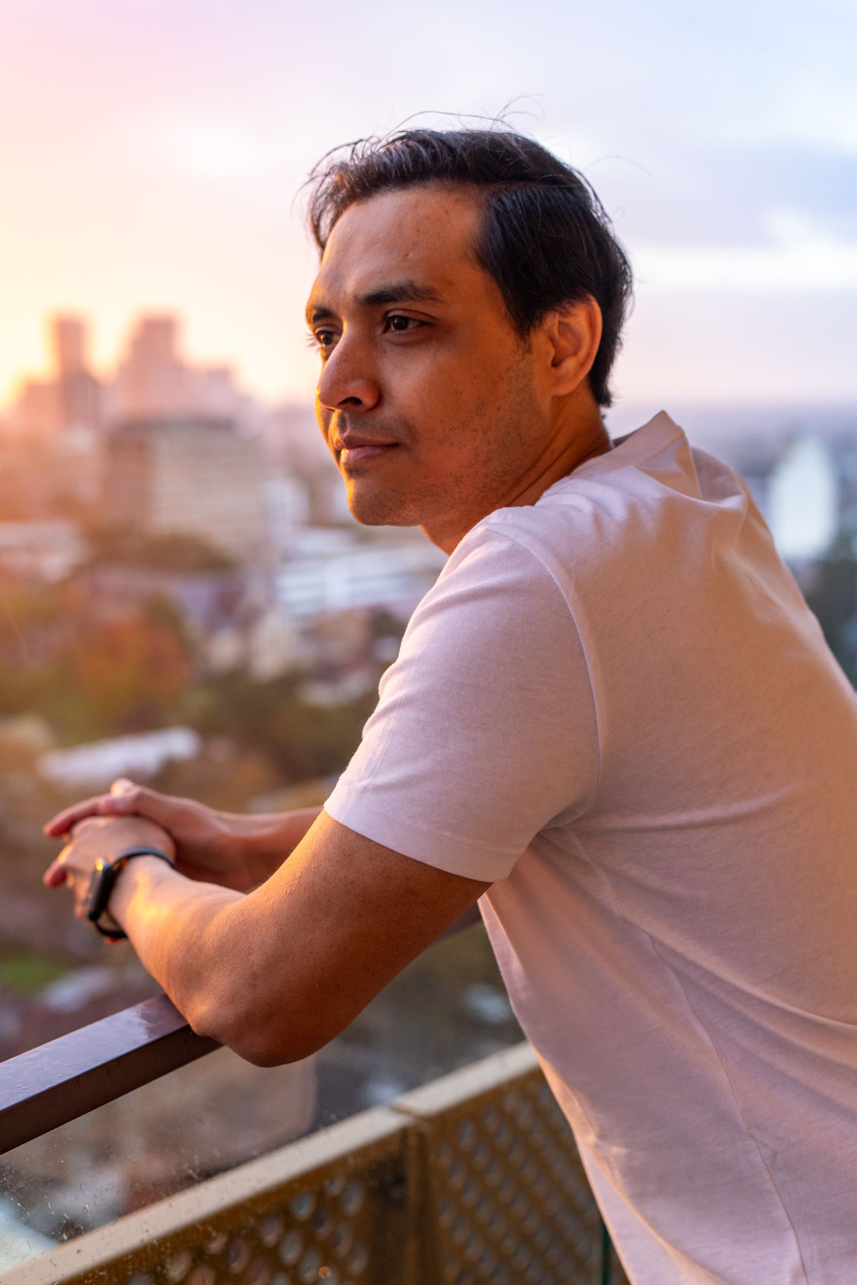 Ext: Young Indian man at sunset having an eye-catching dating portrait taken by dating photographer Georgie Greene in Sydney NSW