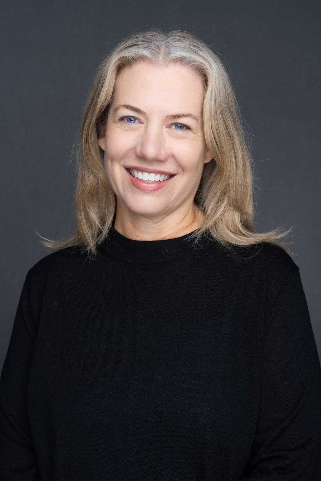 Int: young blonde woman in a black having Business head shots taken by headshot photographer Georgie Greene in Sydney NSW