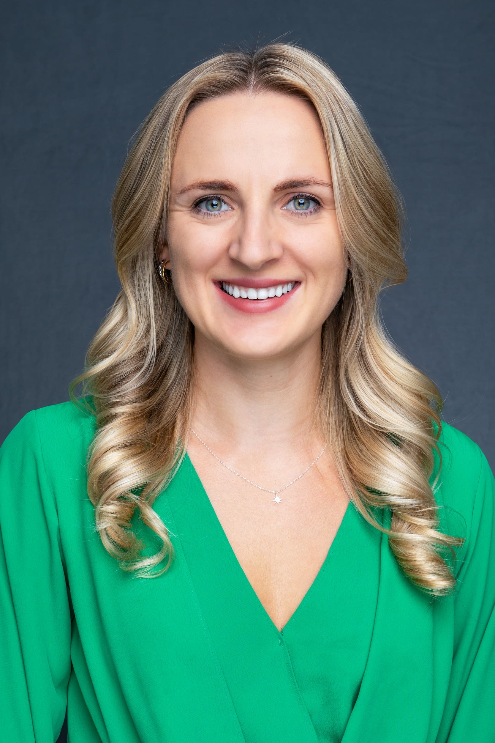 Int: young blonde woman in a green having Business head shots taken by headshot photographer Georgie Greene in Sydney NSW