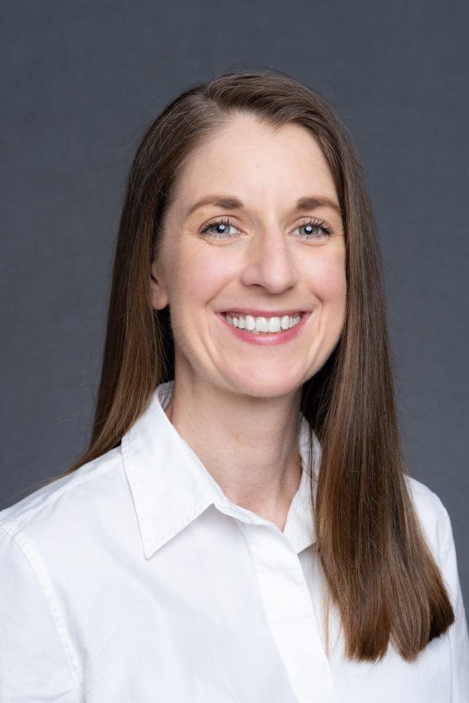 Int: Young woman wearing a white skirt having LinkedIn headshot taken by Professional Photographer Georgie Greene in Sydney NSW