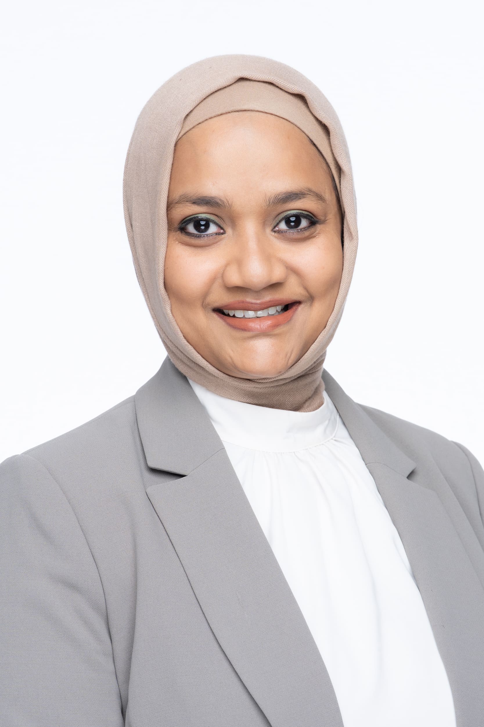 Int: Young Muslim woman wearing a grey jacket having LinkedIn headshot taken by Professional Photographer Georgie Greene in Sydney NSW