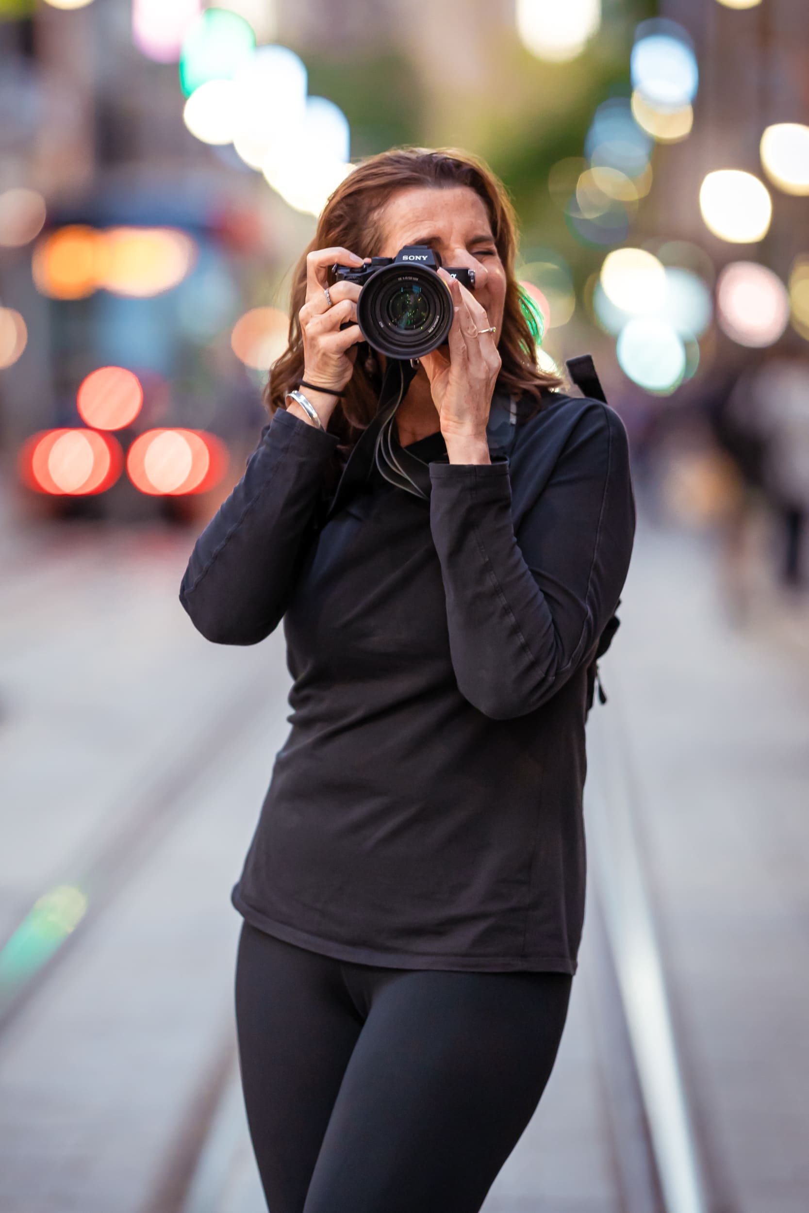 Georgie Greene Corporate Headshots photographer taking a photograph in a Sydney Street