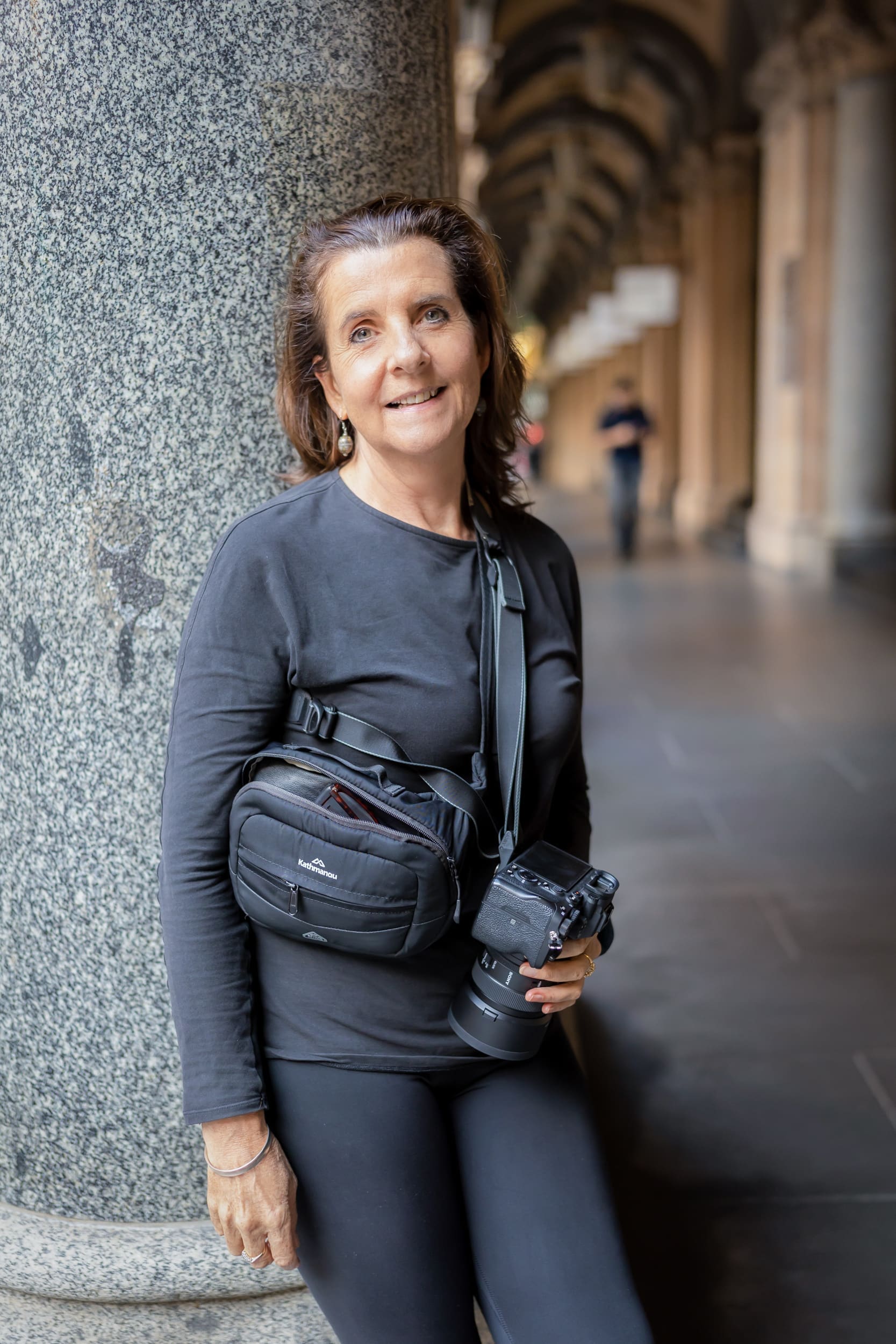 Georgie Greene Dating photographer standing by a stone pillar in a Sydney Street
