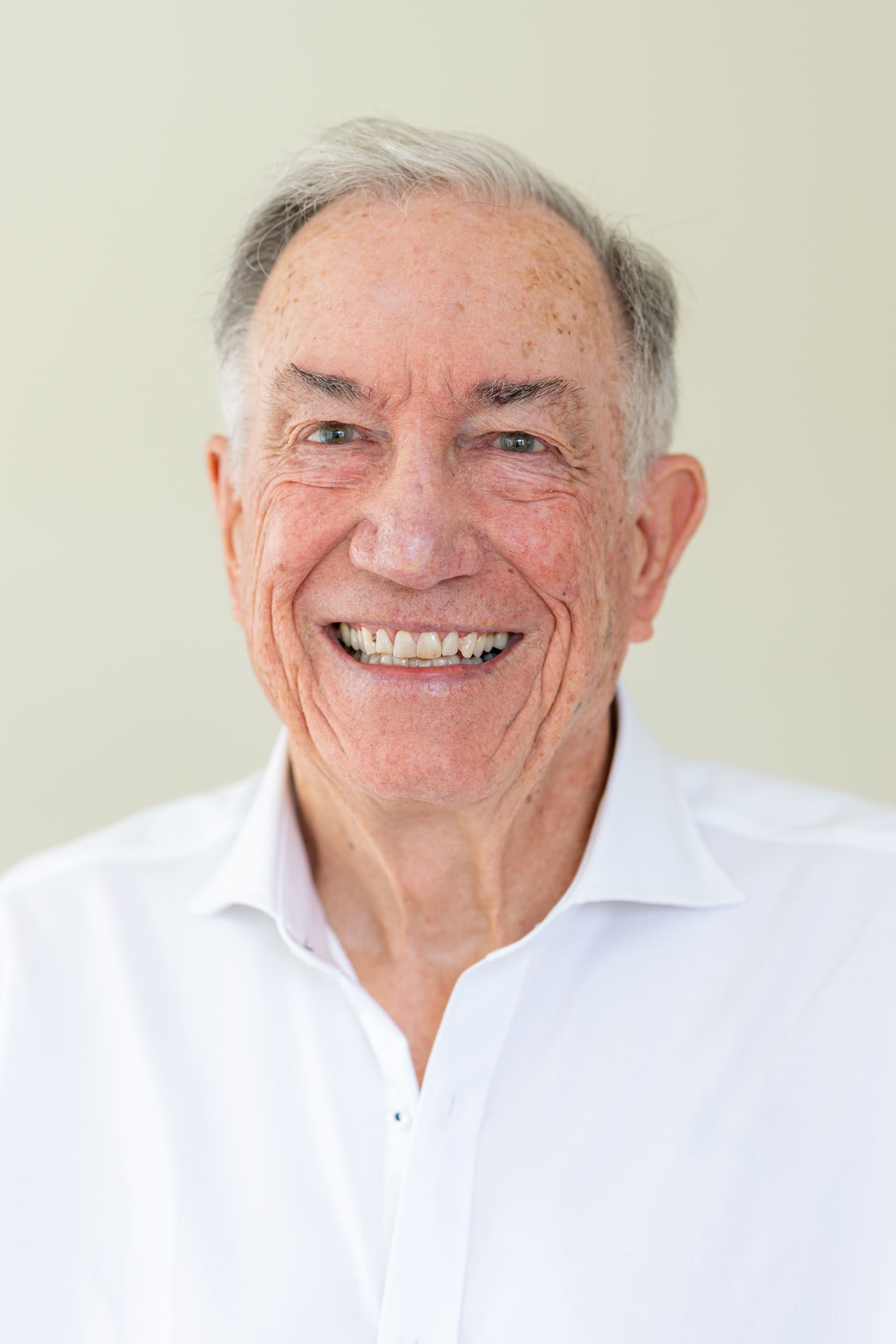 Int: Older man in a white shirt having his headshot photo taken by Sydney corporate photographer Georgie Greene