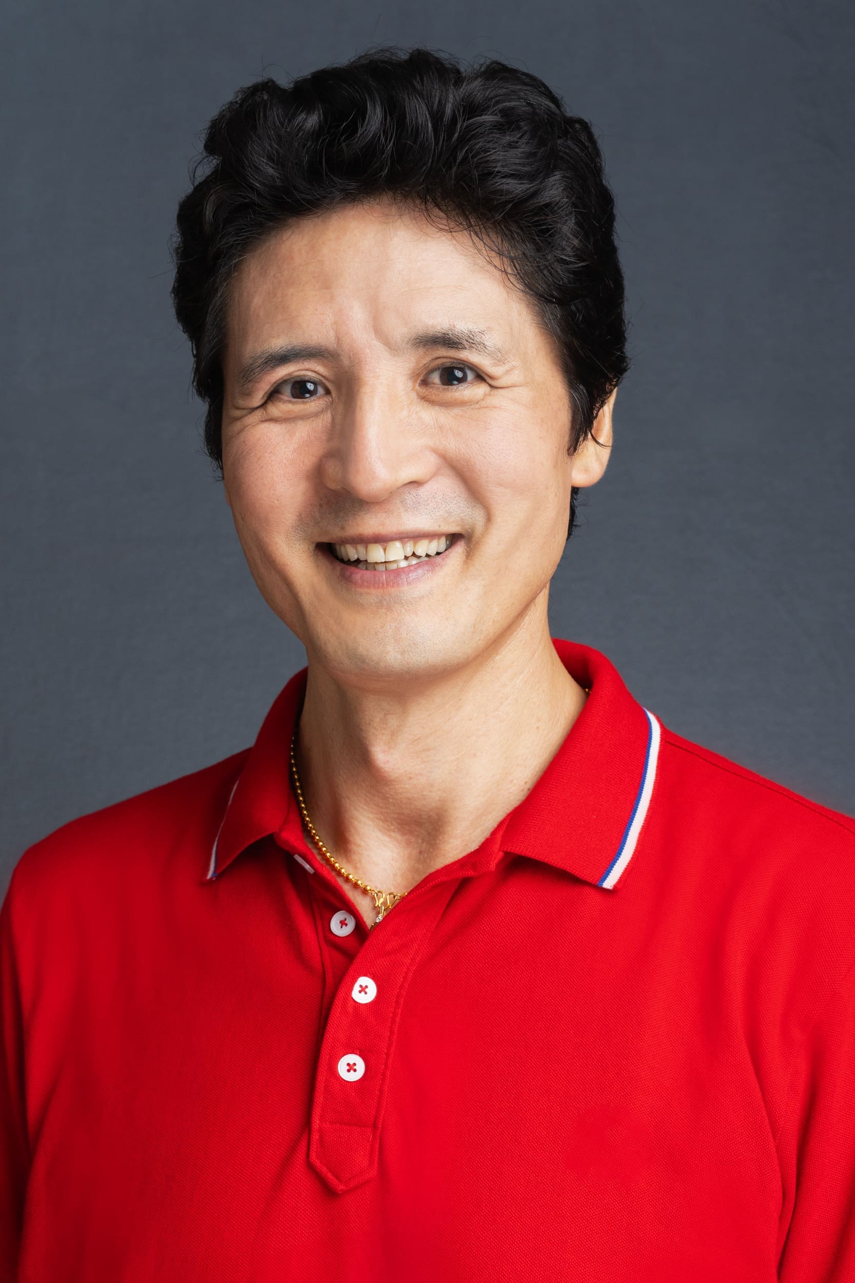 Int: young Tibetan man wearing red having professional headshots taken by Sydney Headshots Photographer Georgie Greene in Sydney NSW