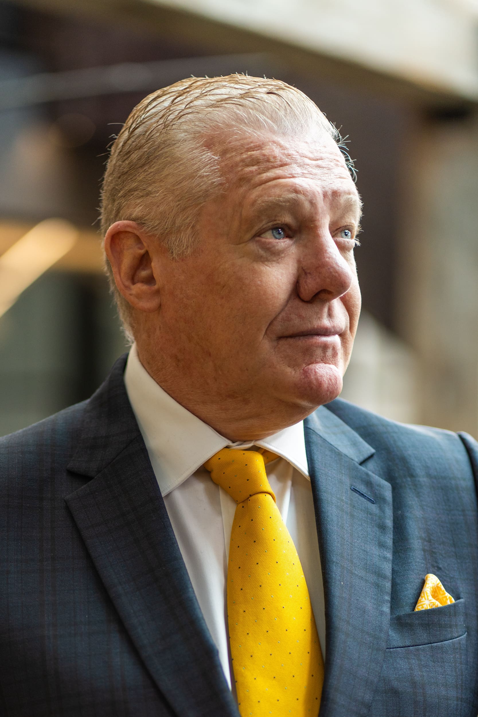 Int: Older man in a suit and yellow tie having a corporate headshot photoshoot with headshot photographer Georgie Greene in Sydney NSW