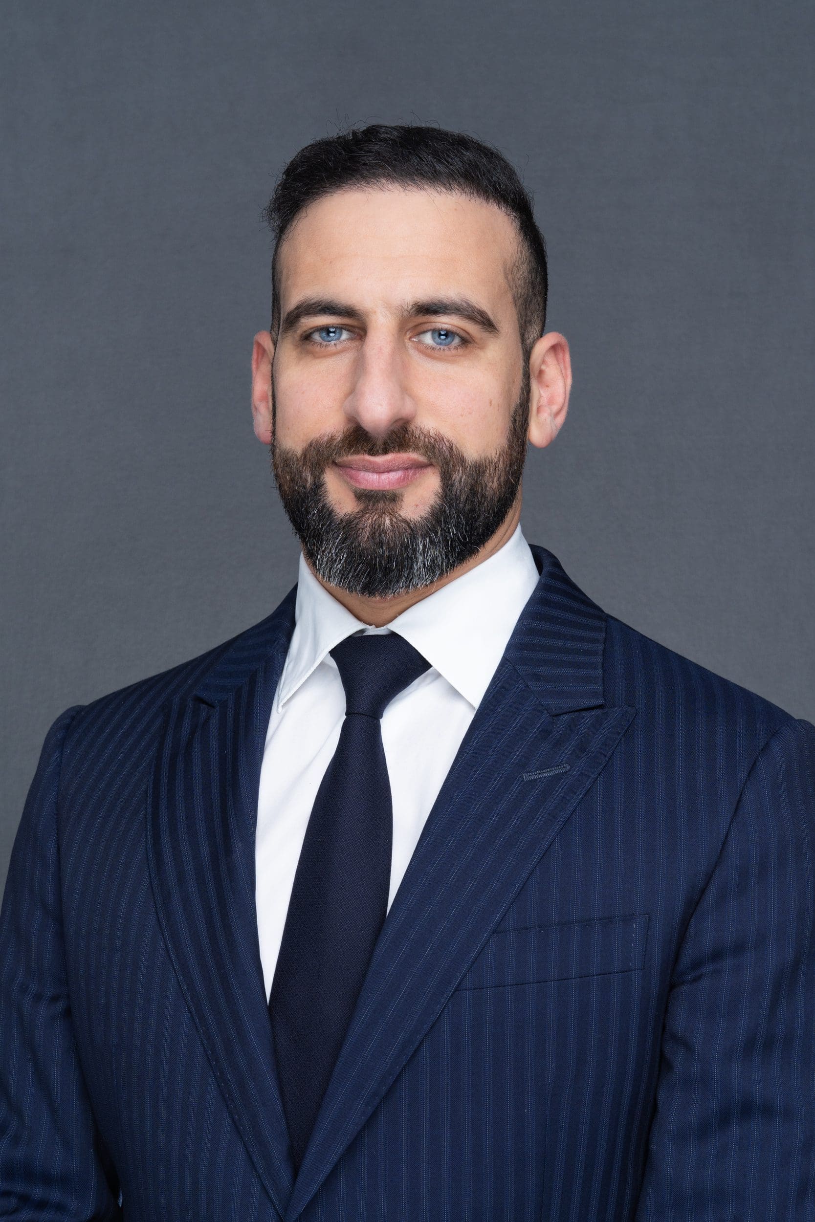 Int: Dark-haired man with a beard having his professional headshot taken by Sydney Headshots Photographer Georgie Greene in Sydney NSW