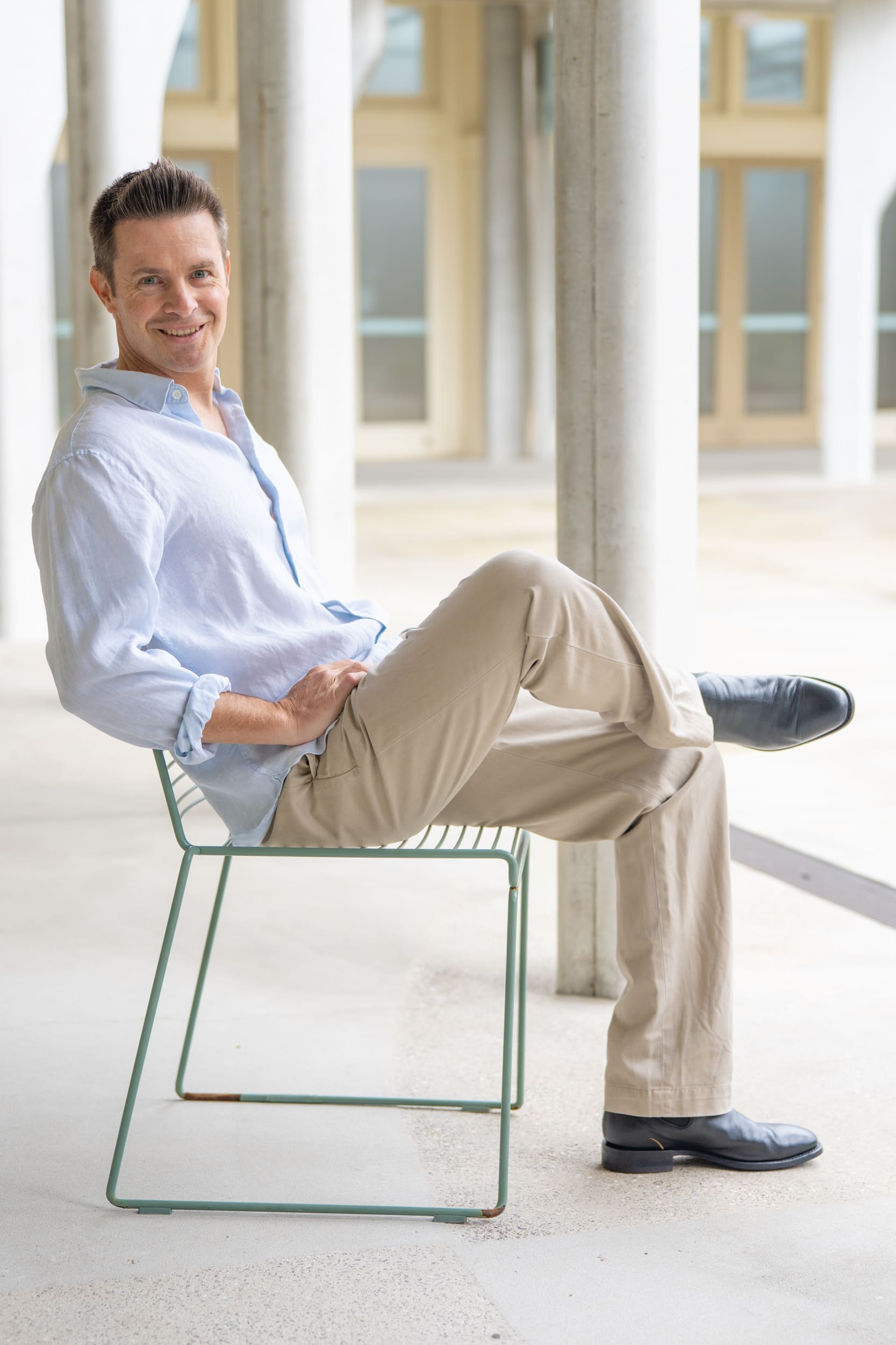 Ext: Young man sitting on a chair having a relaxed dating portrait taken by dating photographer Georgie Greene in Sydney NSW