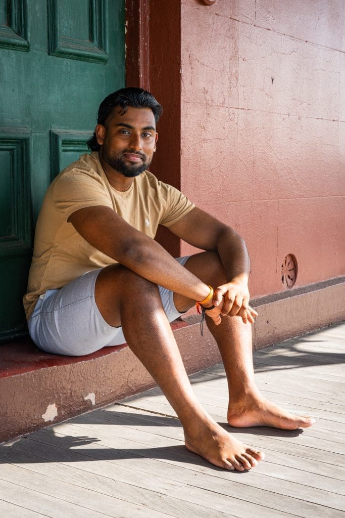 Ext: Young Indian man in bare feet having a relaxed portrait taken by dating photographer Georgie Greene in Sydney NSW