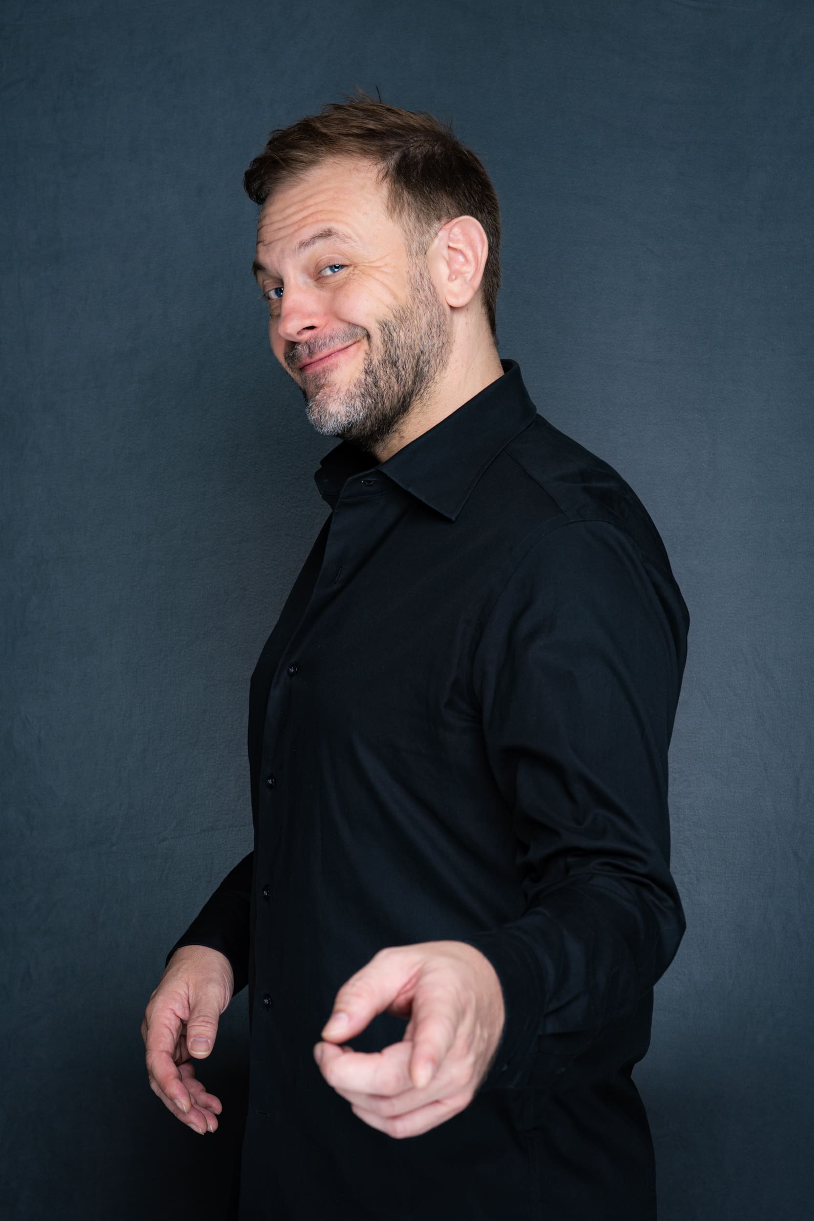 Int: Stand-up Comedian in a black shirt against a grey backdrop Personal Branding Photos Sydney NSW