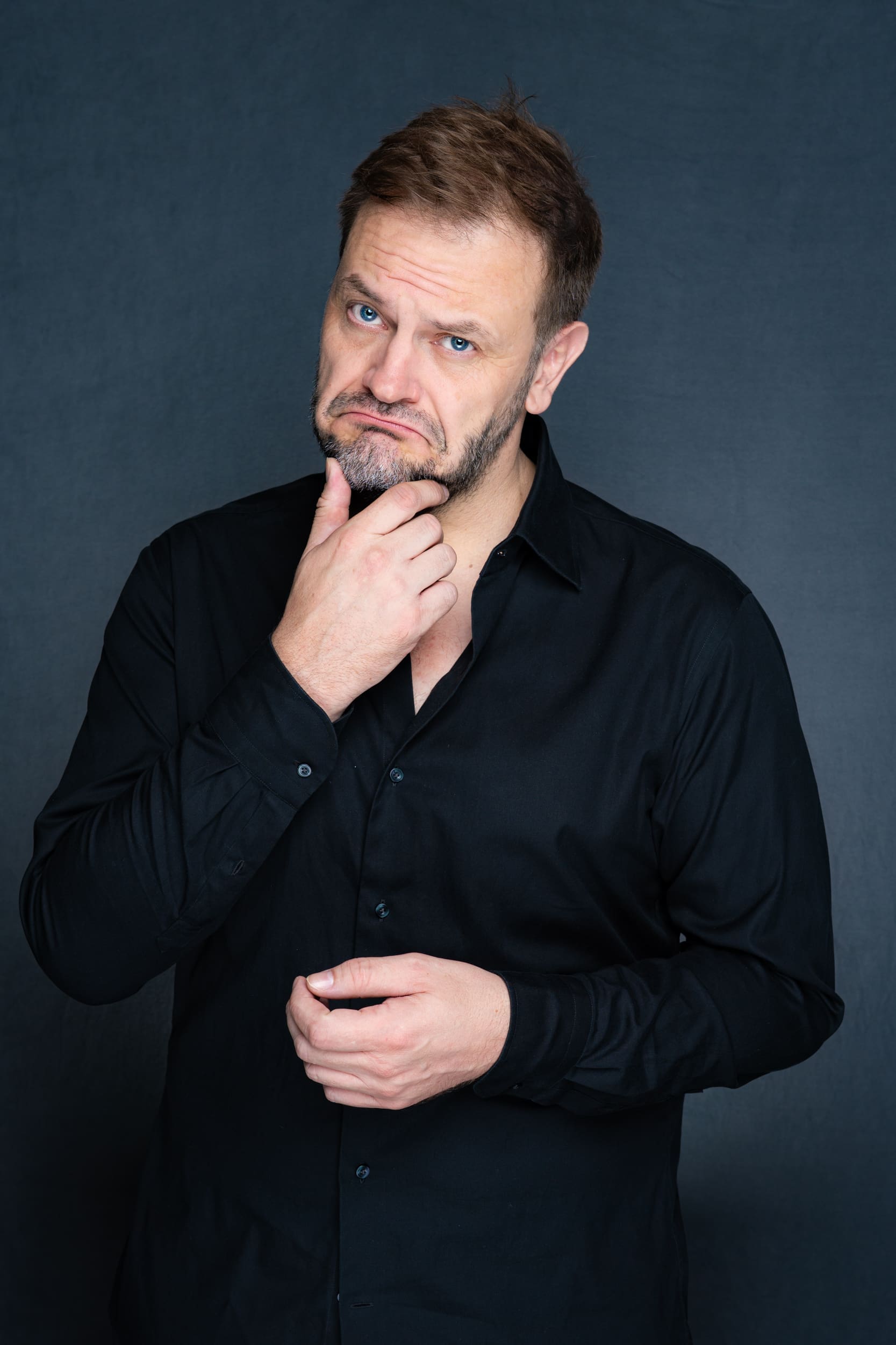 Int: Stand-up Comedian in a black shirt against a grey backdrop Branding Photos Sydney NSW