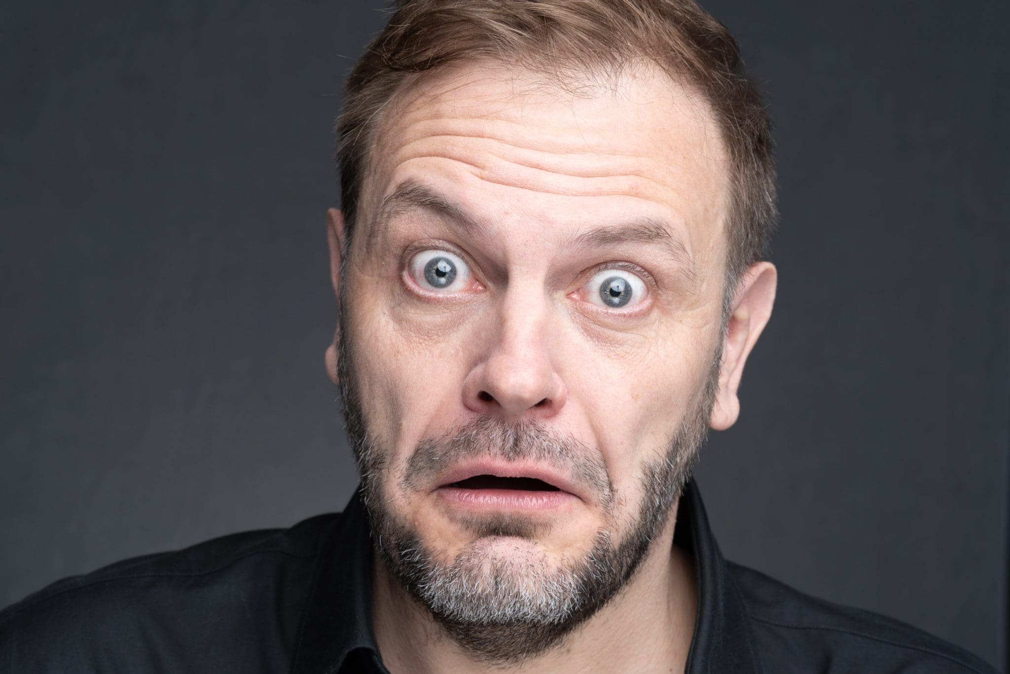 Int: Stand-up Comic in a black shirt against a grey backdrop Personal Branding Photography Sydney NSW