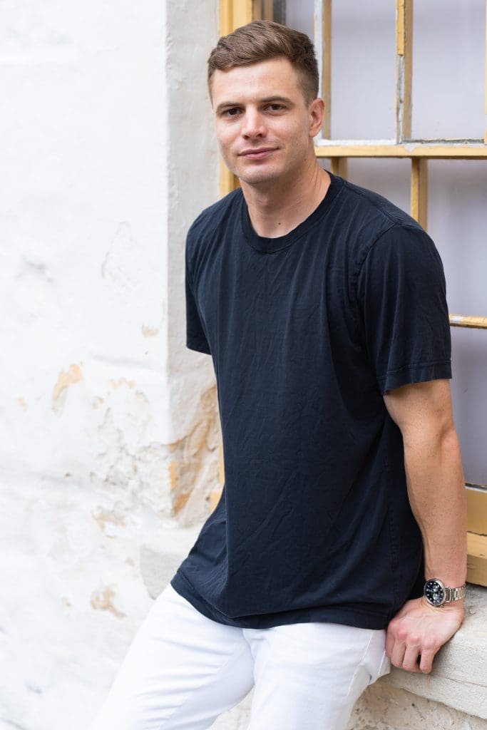 Ext: Young man in a black t-shirt having a dating photoshoot with dating app photographer Georgie Greene in Sydney NSW