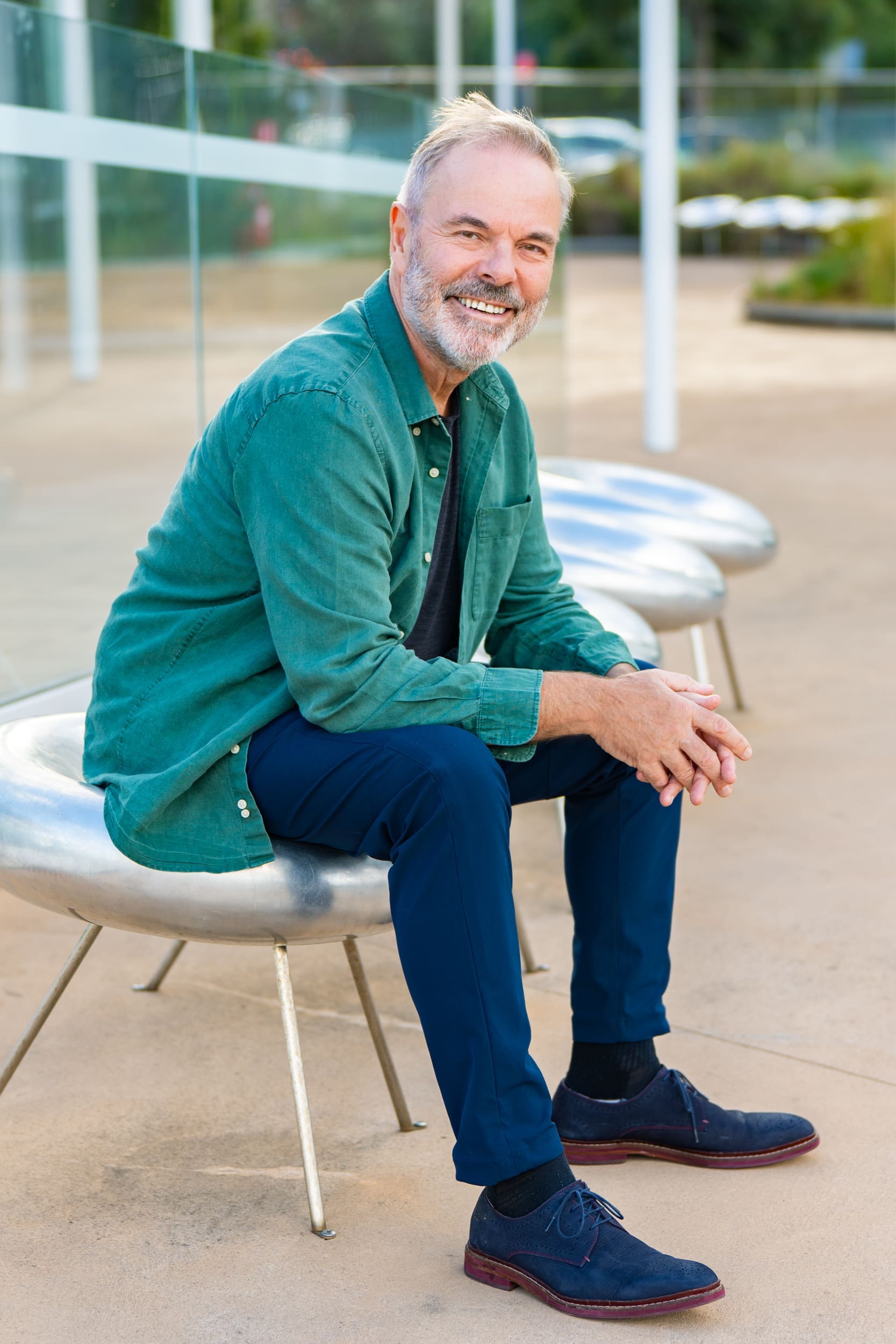 Ext: Journalist sitting on a seat having his personal branding taken by Georgie Greene Photography in Sydney NSW