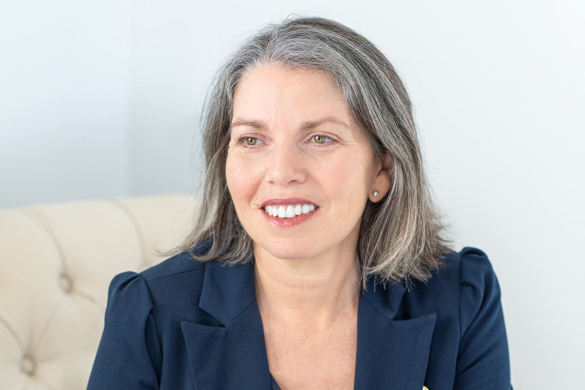 Int: Leadership coach/author wearing a red top having her branding photos taken by portrait photographer Georgie Greene in Sydney NSW