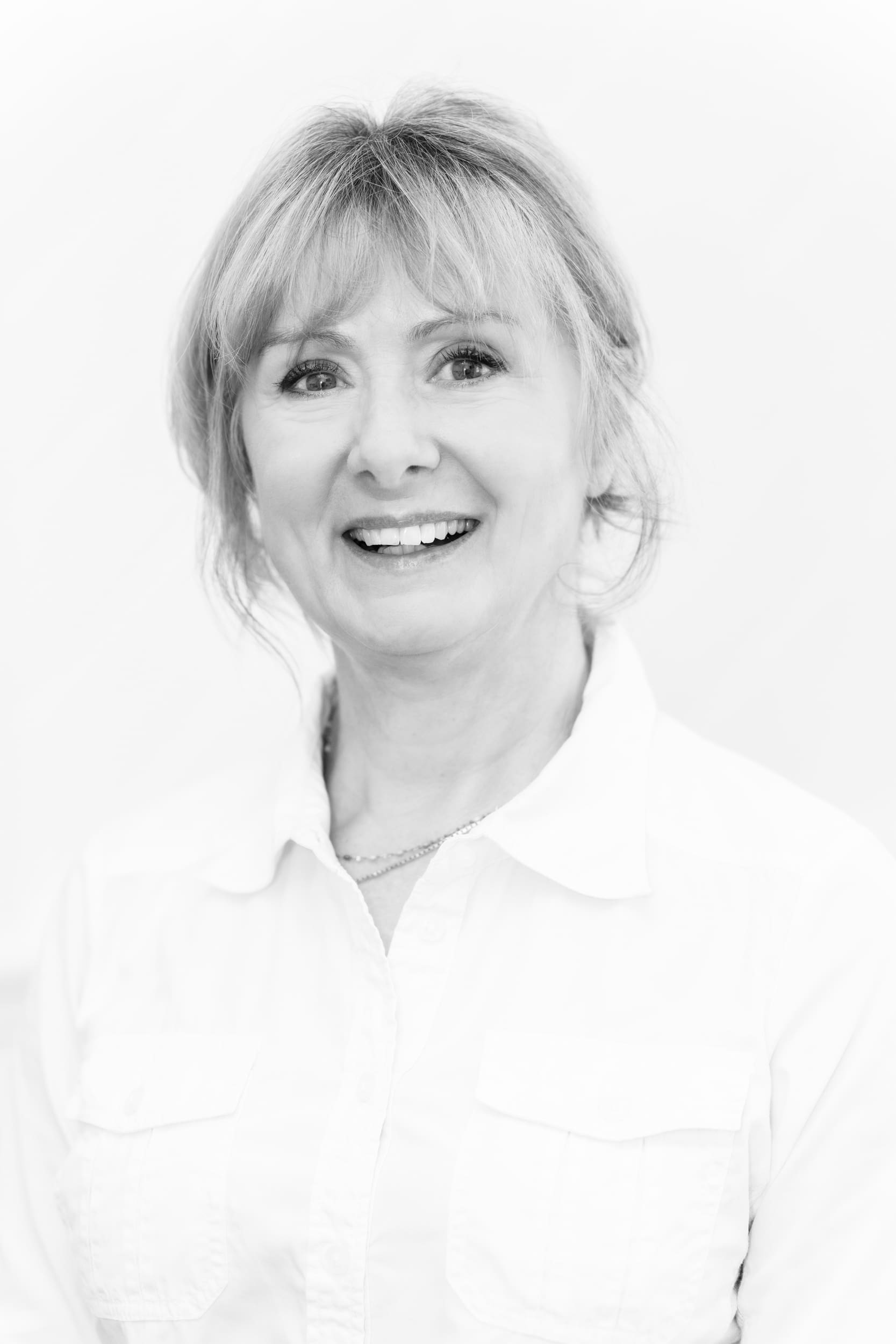 Older woman wearing a white shirt having her portrait taken by portrait photographer Georgie Greene Sydney NSW