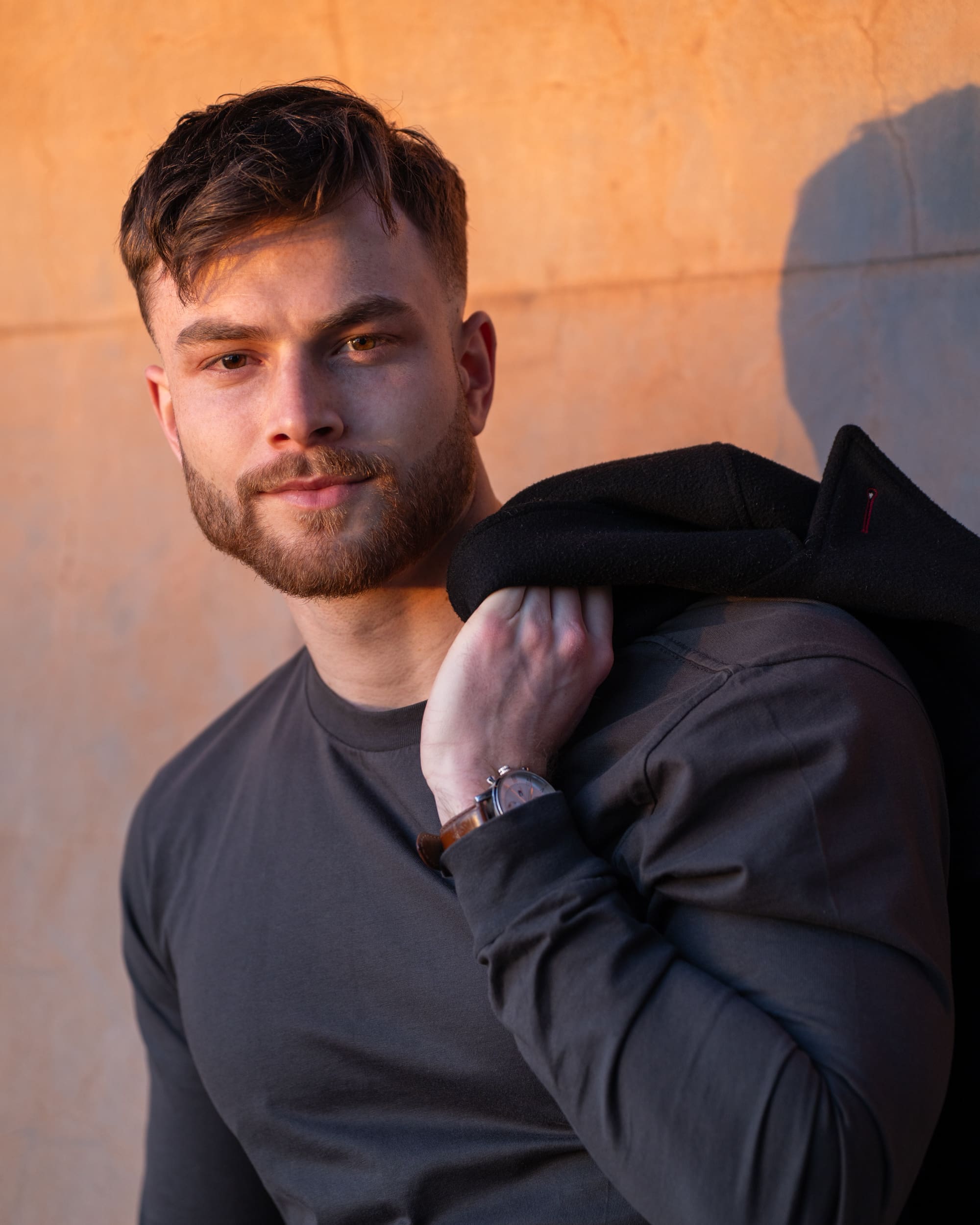 Dark haired bearded young man in dark top having actor headshots taken by Sydney professional photographer Georgie Greene