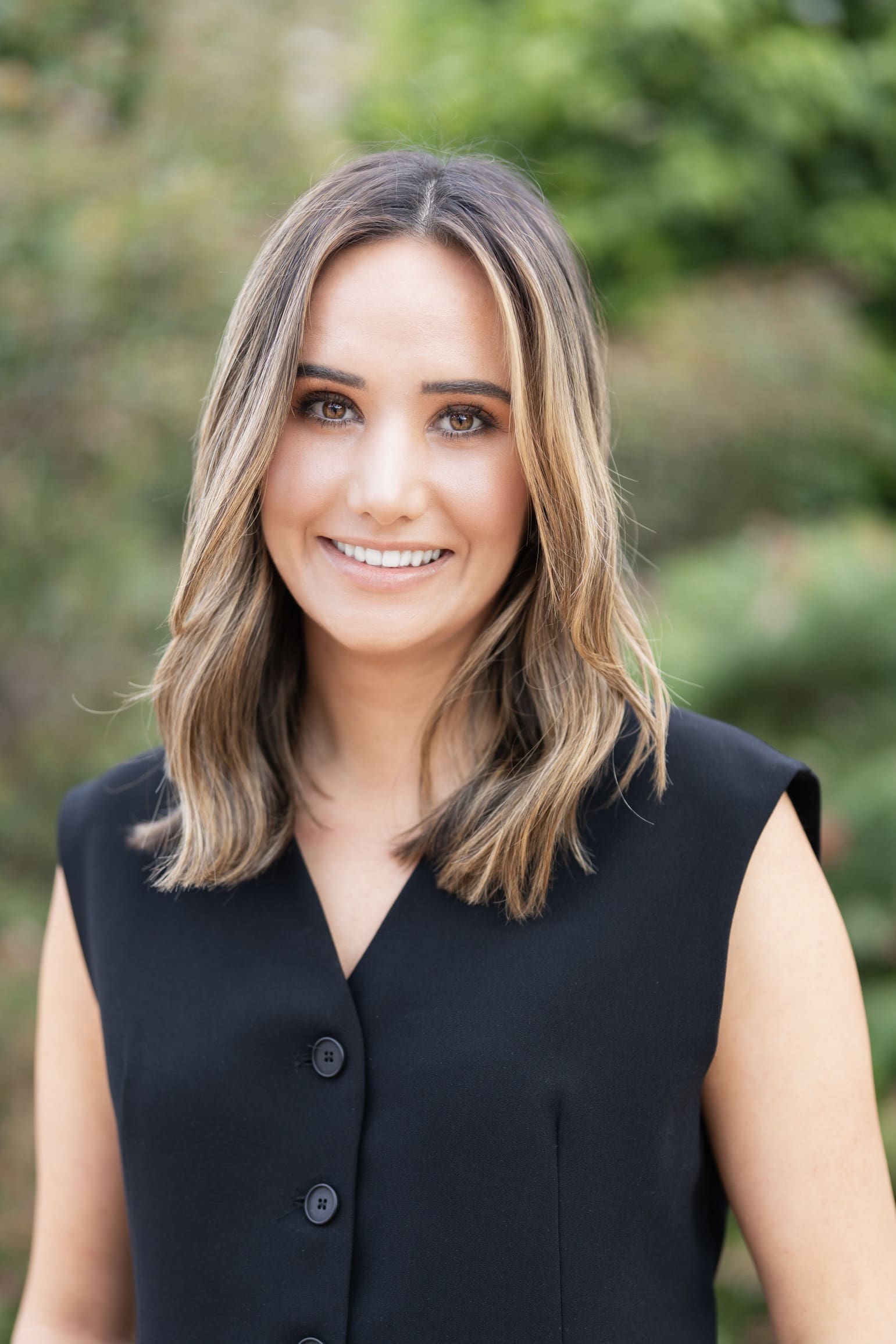 Young blonde journalist wearing a black top having her headshot taken by Sydney professional photographer Georgie Greene