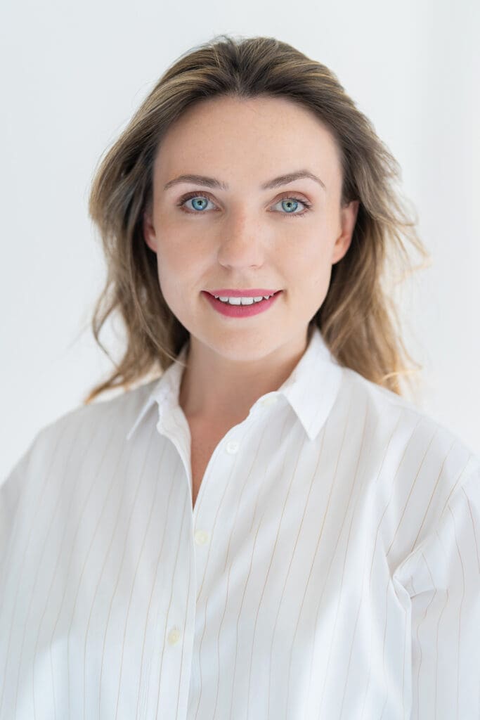 Young woman in a white top having your LinkedIn headshot taken by professional photographer Georgie Greene Sydney NSW
