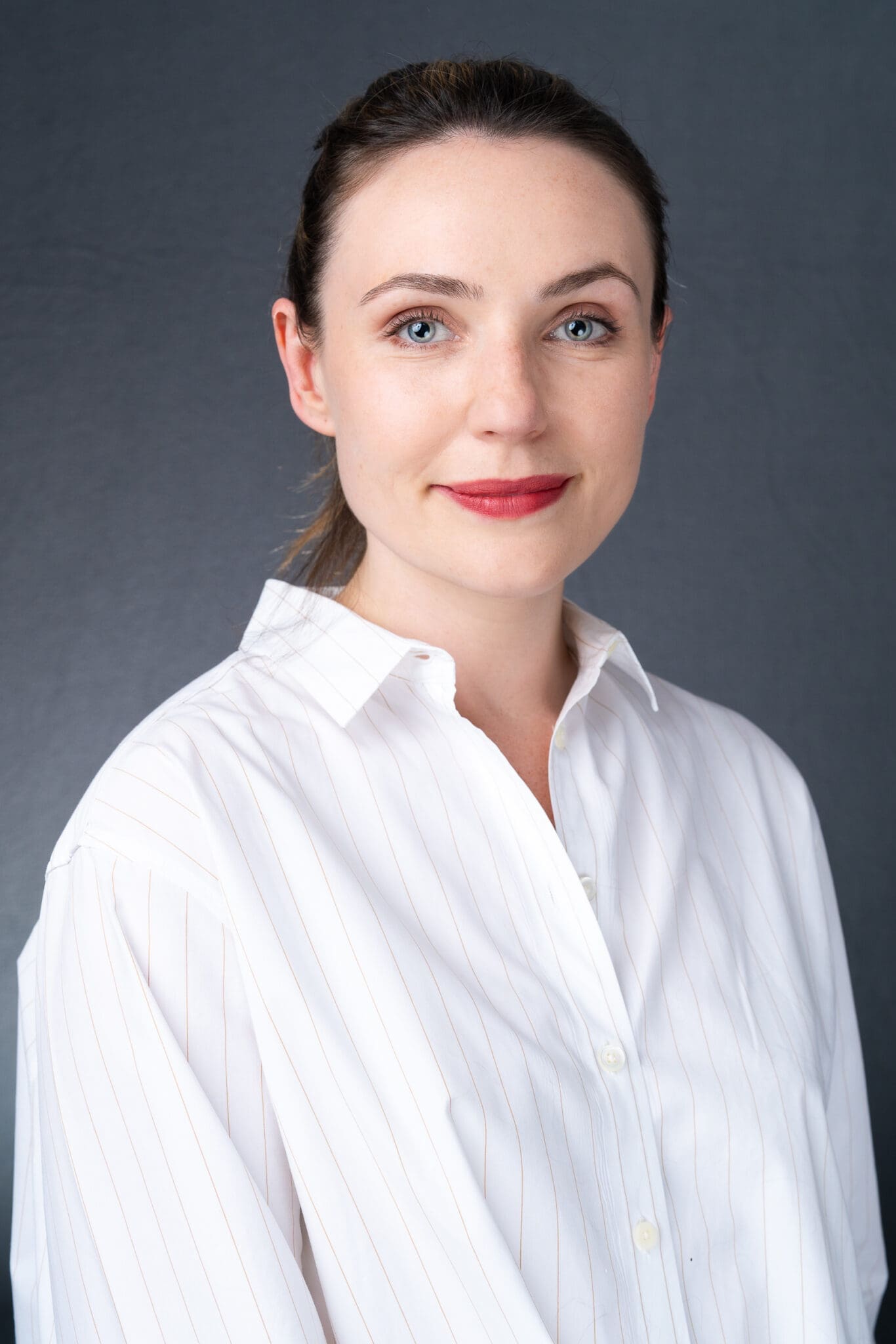 Young woman in a white top having your headshot taken by a mobile studio with Sydney photographer Georgie Greene
