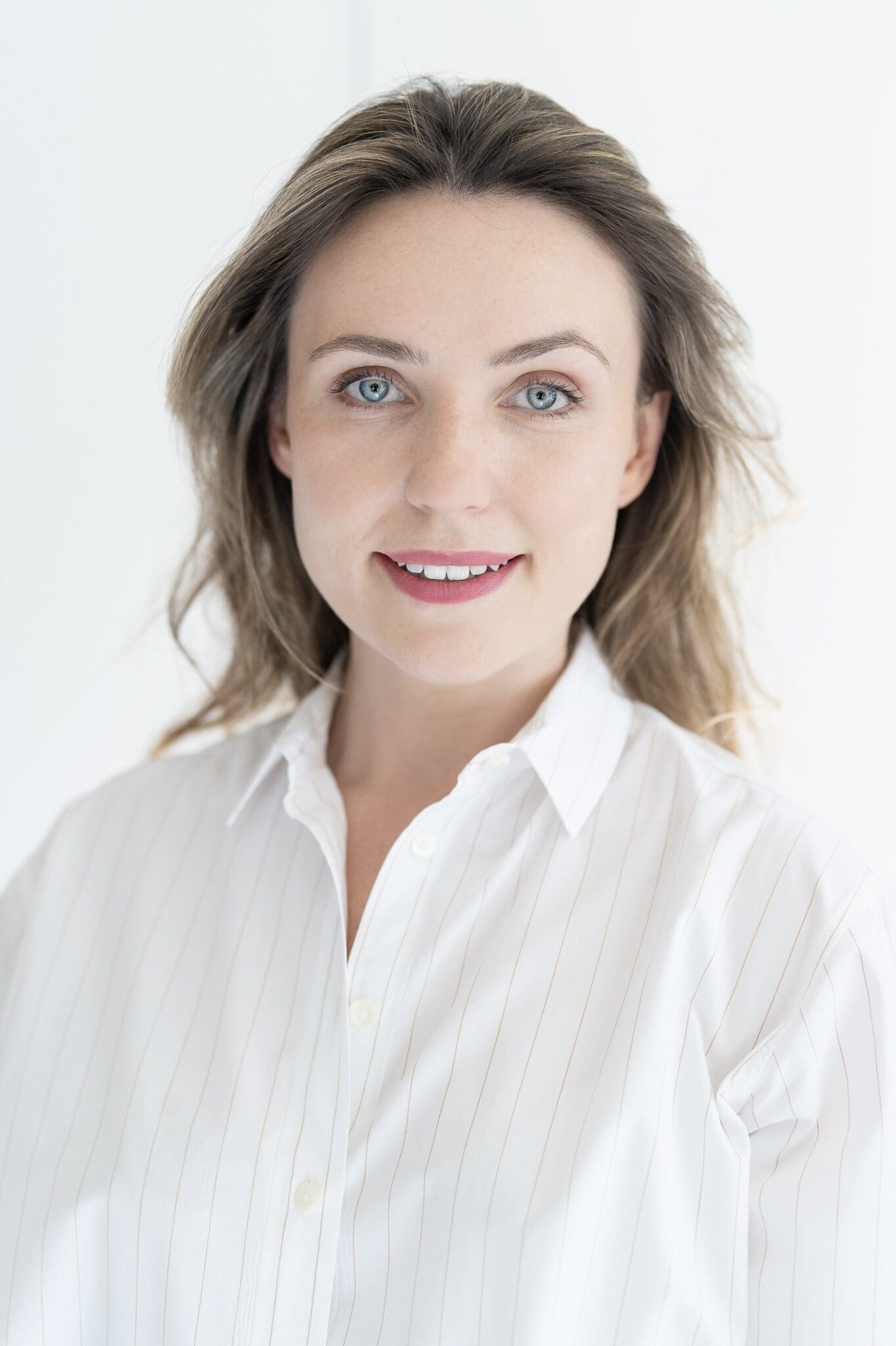 Young woman in a white top having your LinkedIn headshot taken by professional photographer Georgie Greene Sydney NSW
