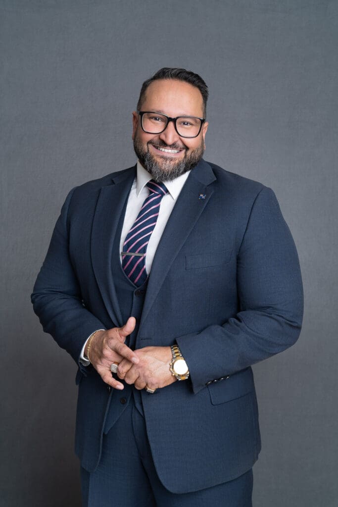 Man with a beard and glasses wearing a three piece suite having his corporate headshot taken by professional photographer Georgie Greene