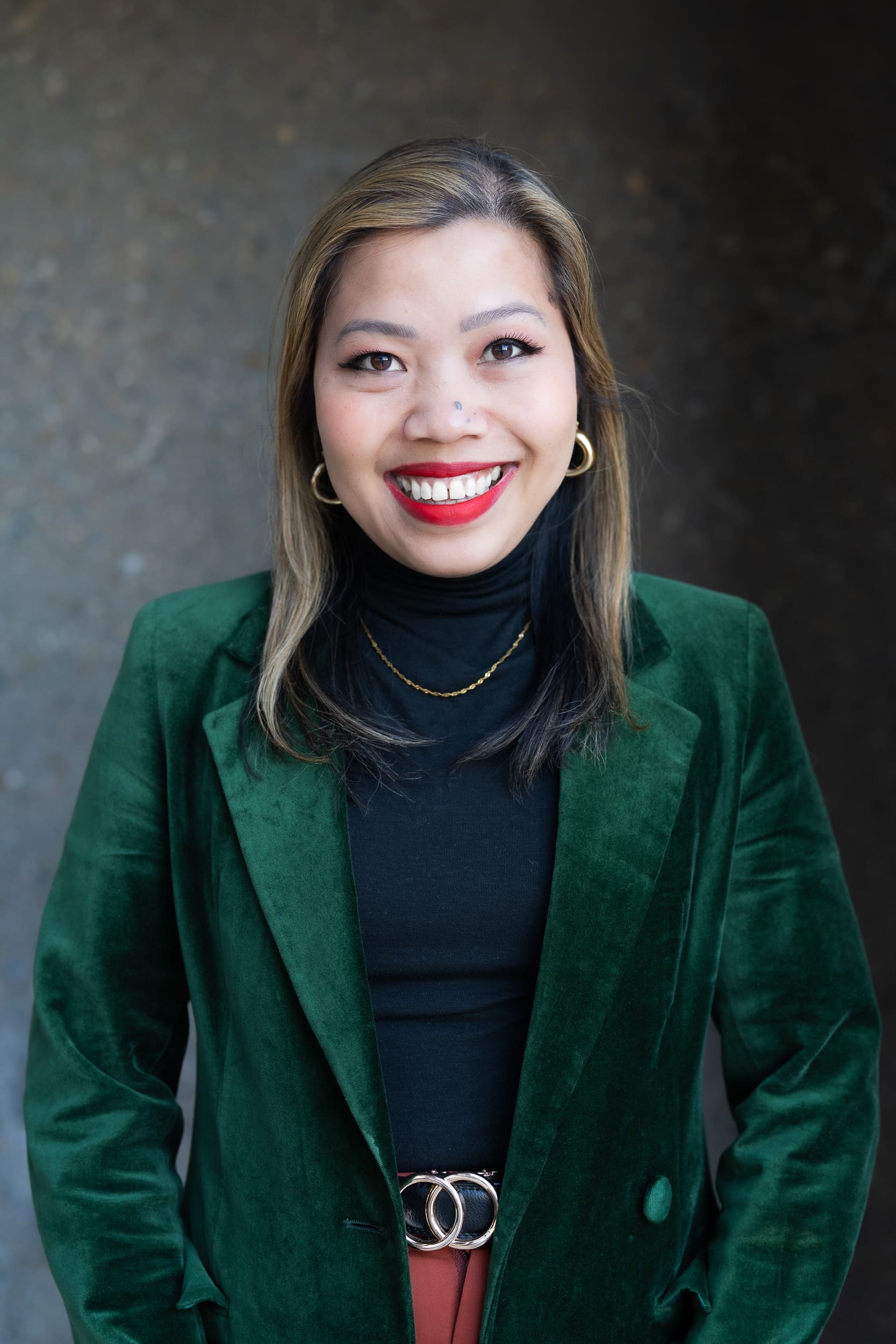 Indonesian business woman wearing a green jacket having her personal branding headshot taken by Sydney headshot photographer Georgie Greene