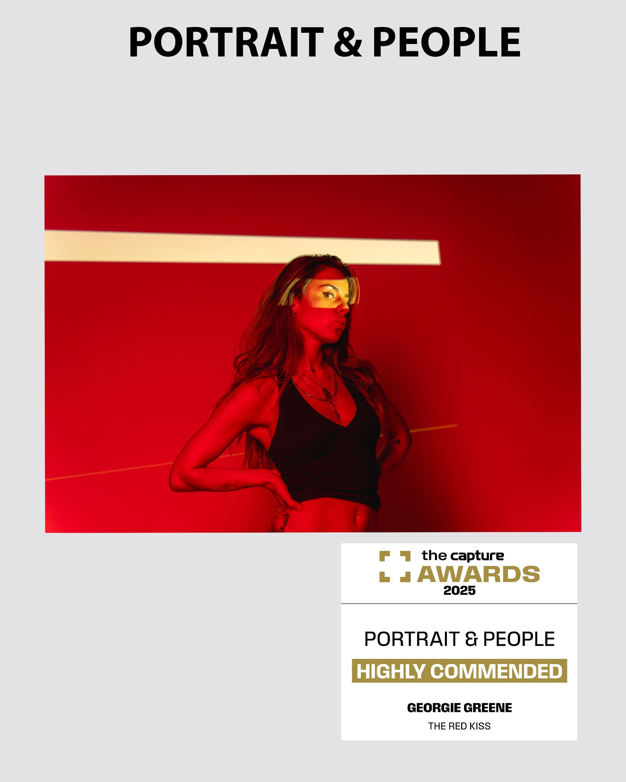 Portrait of a model in red light kissing the air