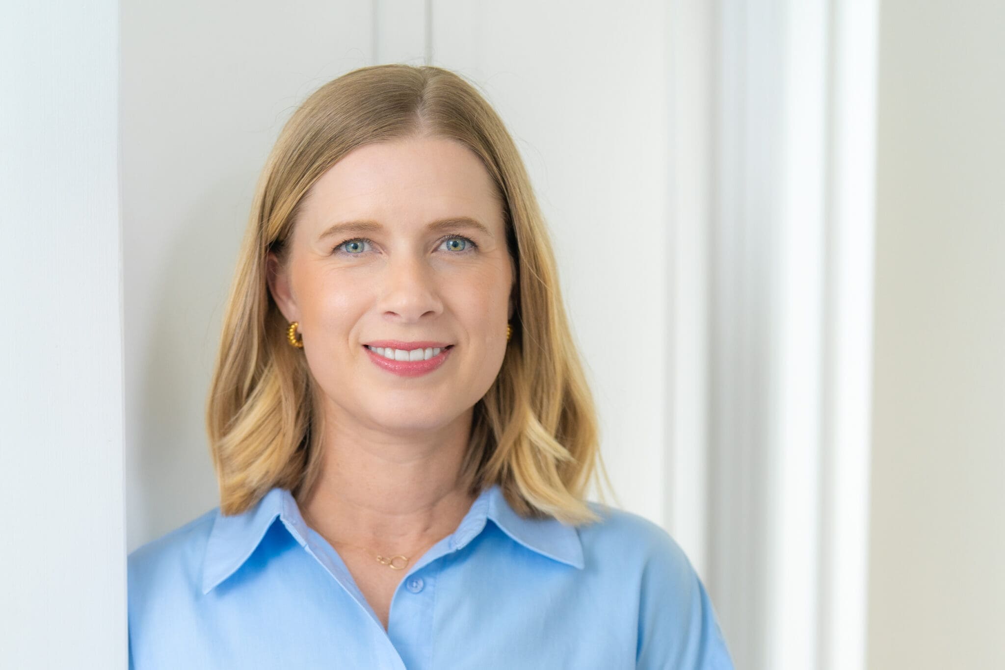Woman in a blue top having her personal branding portrait taken by Sydney personal branding photographer Georgie Greene